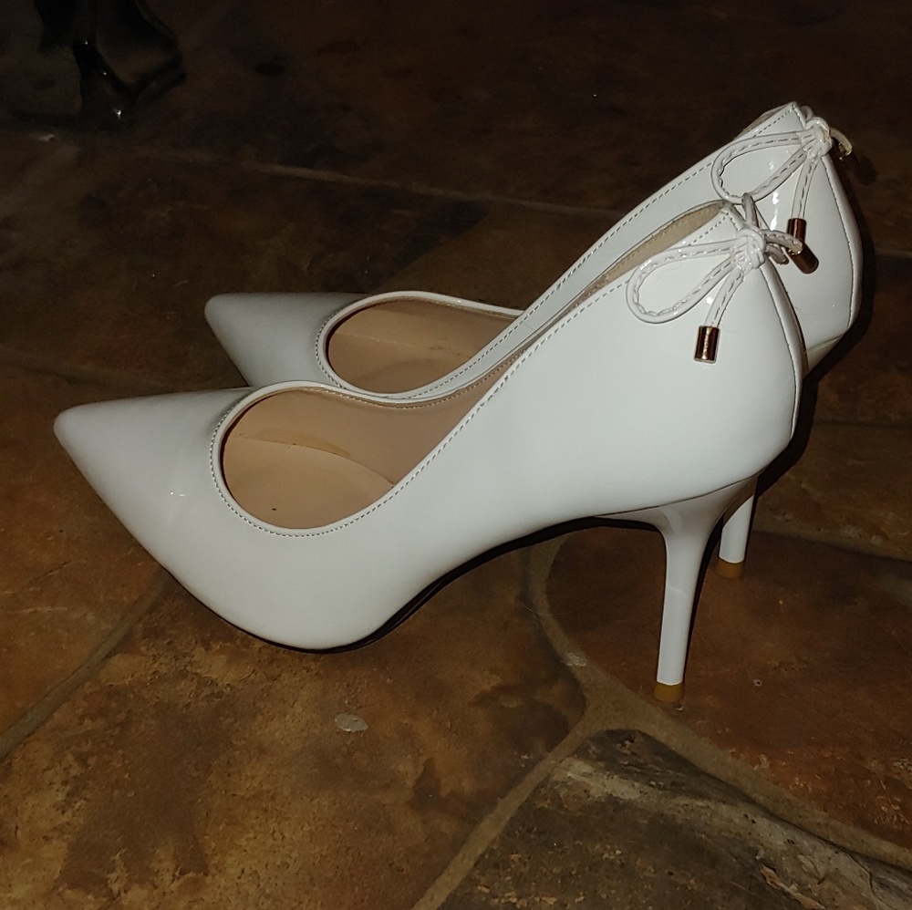 White pumps with bows on back